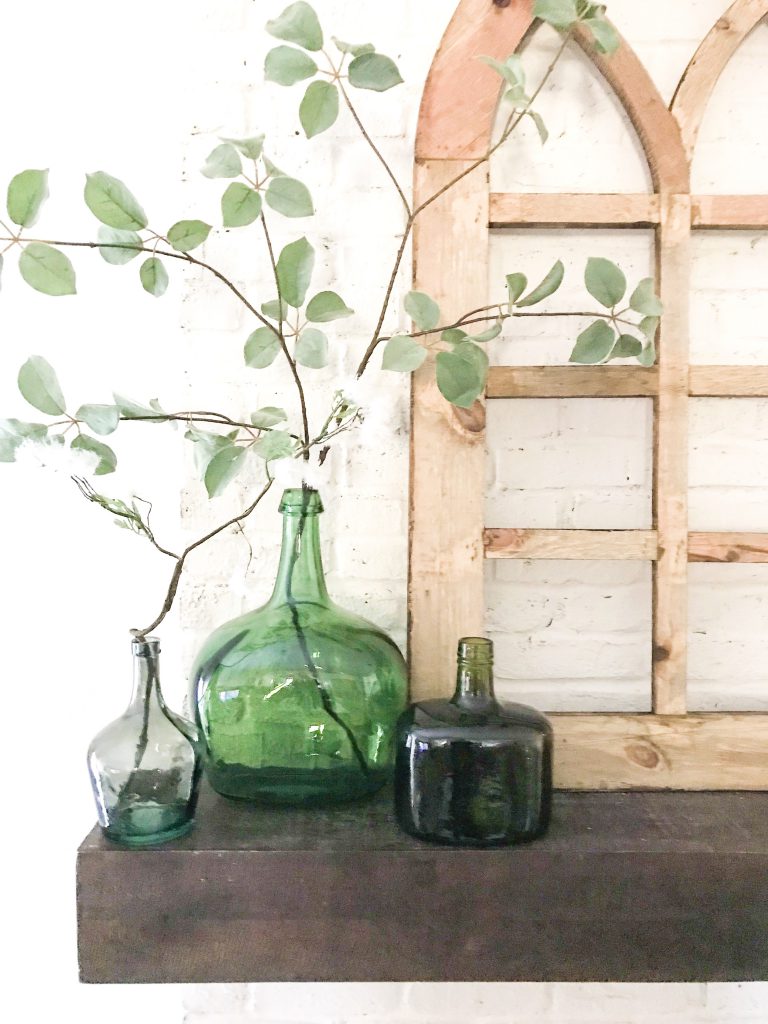 green bottles on mantel