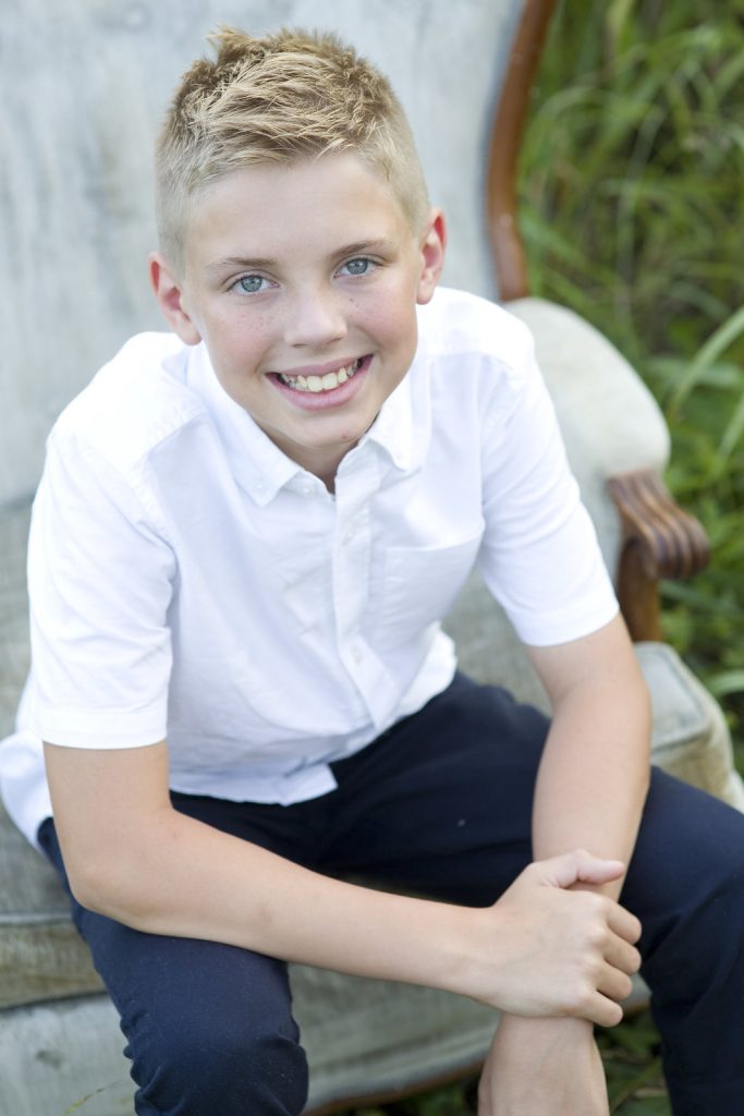 young boy sitting in chair