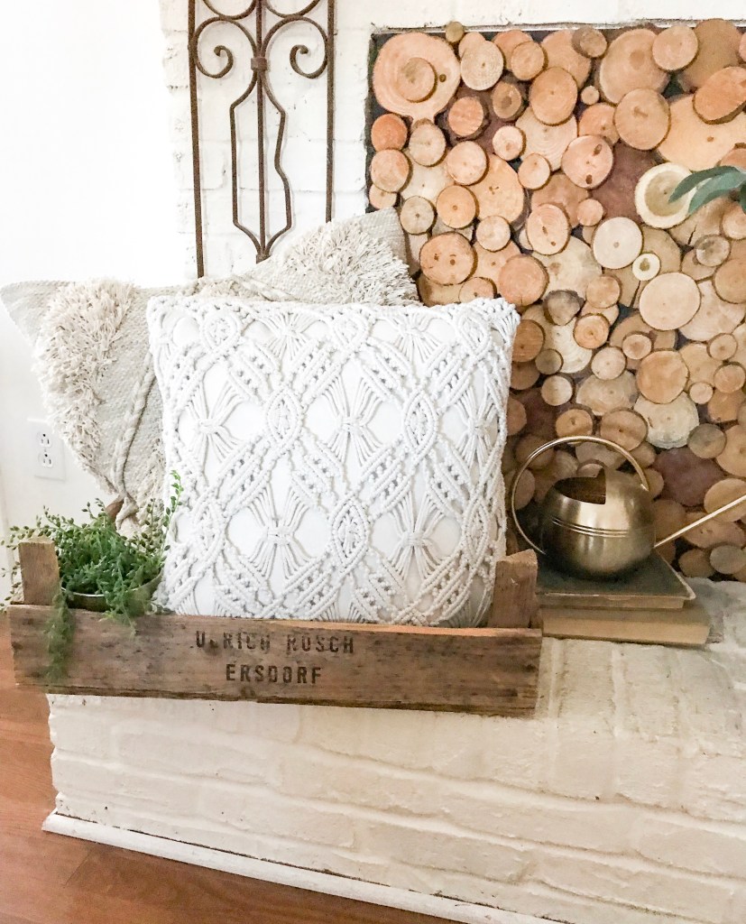 gold watering can on fireplace