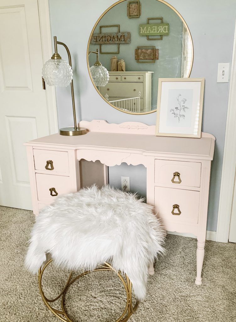 pink vanity with gold round mirror