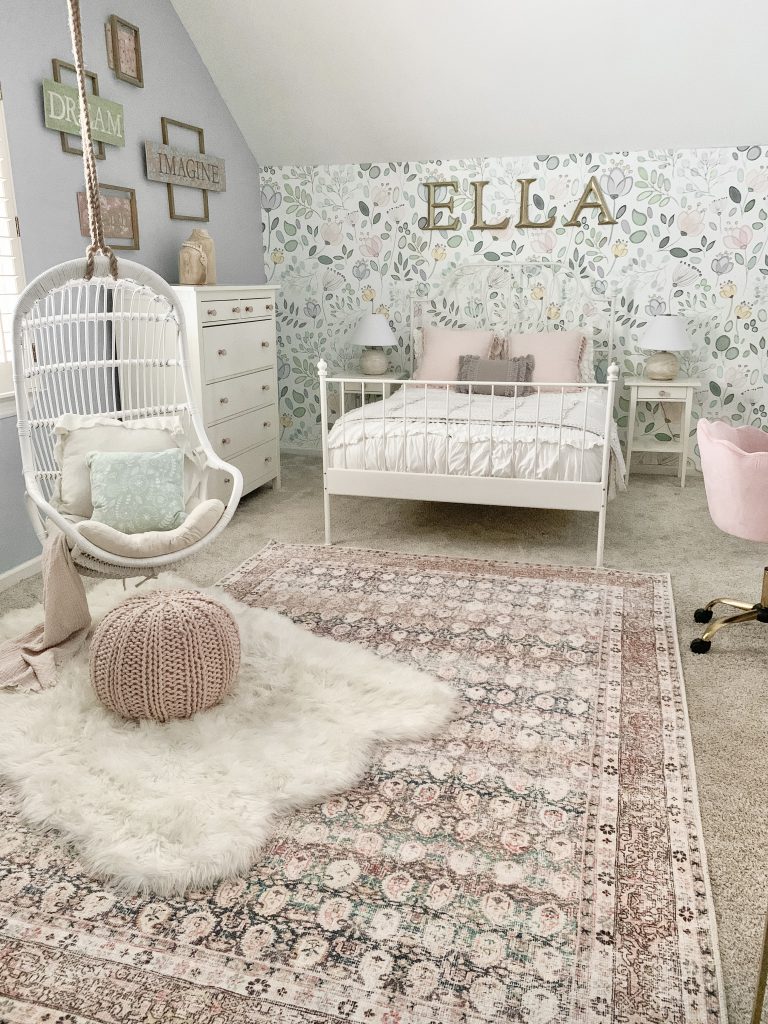 girl's room with bed and hanging swing with blue walls