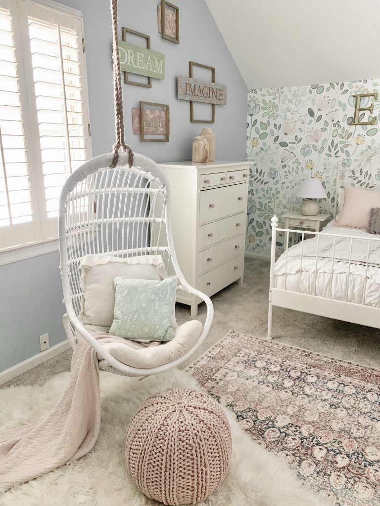 hanging white rattan chair in front of window