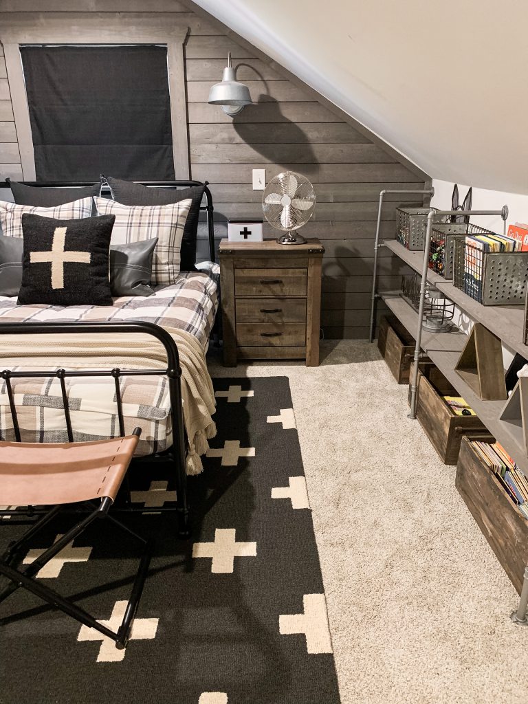 pipe shelves on side of attic room transformed into boy's room